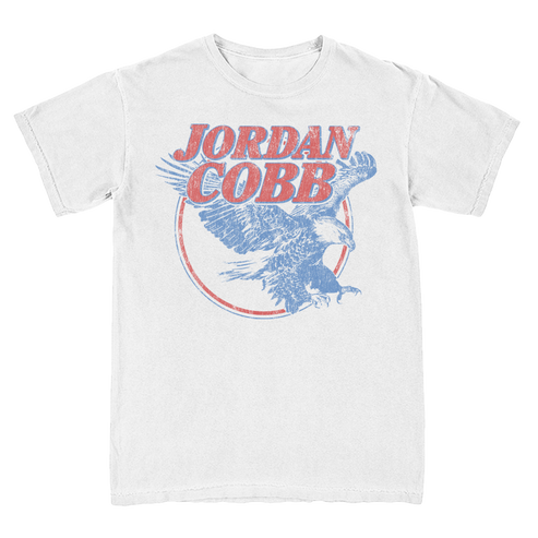 A white short-sleeve t-shirt featuring a distressed graphic print of an eagle and the text 'JORDAN COBB' in red and blue.