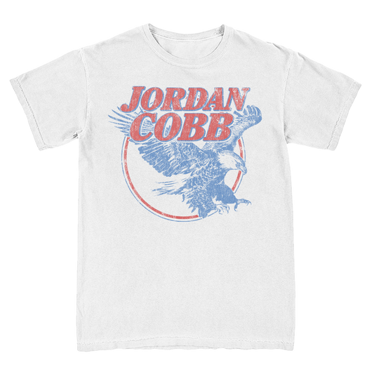 A white short-sleeve t-shirt featuring a distressed graphic print of an eagle and the text 'JORDAN COBB' in red and blue.